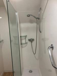 a shower in a bathroom with a glass door at 10 Yards from Sea Hightide – Own Access to Beach in Sheringham