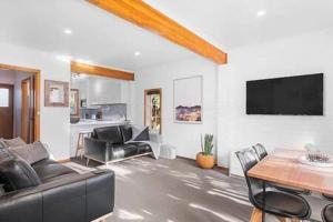 a living room with a couch and a table at Cosy renovated 2 bed villa in superb location in Hobart