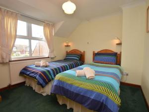 two twin beds in a room with a window at 3 bed in Fishguard 37270 in Fishguard