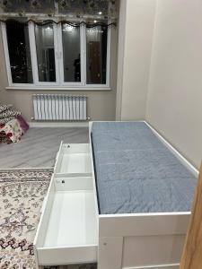 A bed or beds in a room at ЖК Махаббат