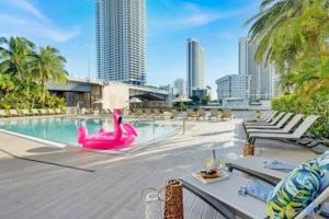 a swimming pool with a pink flamingo in a city at Upper studio Balcony Pool Gym - Near Beach in Hallandale Beach