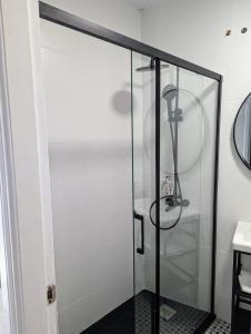 a shower with a glass door in a bathroom at Ático San Juan 2 in Cáceres +21 photos