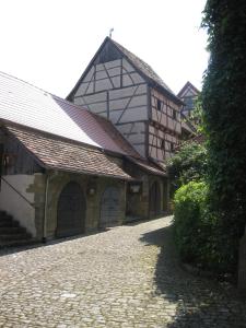 a large building with a stone road in front of it at Apartments Bed & Breakfast Brückner in Willanzheim