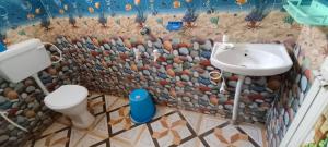 a bathroom with a toilet and a sink at Ocean front beach resort in Tajpur