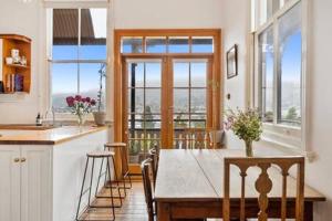 a kitchen and dining room with a table and chairs at Historic Home close to CBD 3Brm with views in Hobart