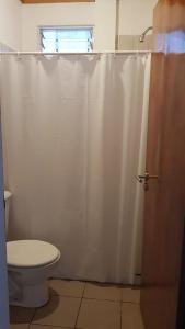 a bathroom with a toilet and a shower curtain at Diamelita in Oberá