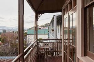 un balcón de una casa con mesa y sillas en Historic Home close to CBD 3Brm with views en Hobart