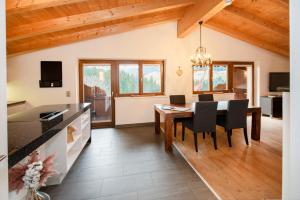 a kitchen and dining room with a table and chairs at Natural Deluxe Apartments Alpbach in Alpbach