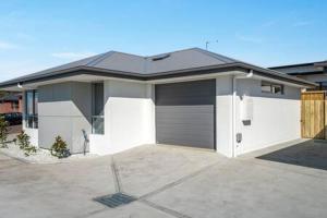a house with a garage with a driveway at New Mod Home 2 bed bath Home 12km to CBD Airport in Rokeby