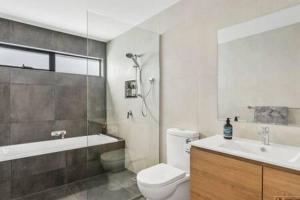 a bathroom with a toilet and a sink and a shower at Mountain View Villa-close to shops-10min to CBD in Bellerive