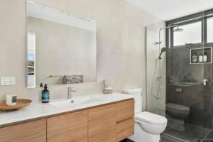 a bathroom with a sink and a toilet and a shower at Mountain View Villa-close to shops-10min to CBD in Bellerive