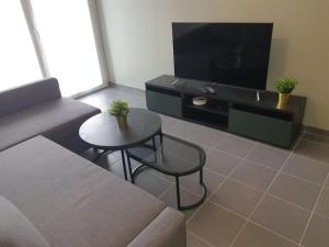 a living room with a couch and a table and a tv at Superbe appartement Evry Centre in Evry-Courcouronnes