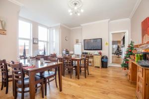 a dining room with tables and chairs and a christmas tree at Marlborough Hotel in Norwich