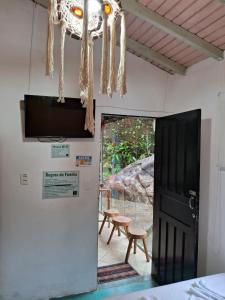 a room with a door and a chandelier at Pousada Familia Viva Trindade in Trindade