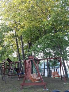 a group of playground equipment in a park at Leśny Zakątek- Domek Lipa in Parchowo
