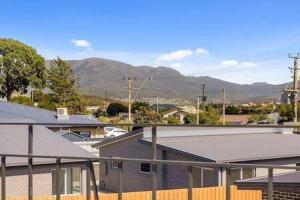 a group of houses with mountains in the background at Residence at 165 Great for large groups Sleeps 11 in Hobart