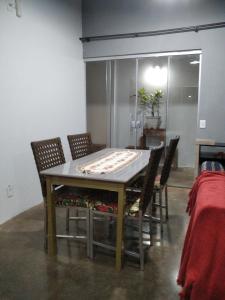 a dining room table with chairs and a table with at CASA INTEIRA MOBILIADA Próx Shopping Norte com Ar e Wifi , Selfie Checkin e Tv FireAmazon in Londrina