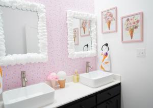 a bathroom with two sinks and two mirrors at Ice Cream Retreat at Casa Kumwesu in Bellmead