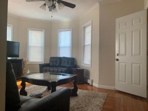 a living room with a couch and a table at Charming Urban Apartment Getaway in Providence