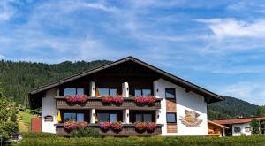 a house with flower boxes on the front of it at Gästehaus Kaindl in Reit im Winkl