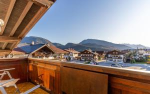 a balcony with a view of a town and mountains at Gästehaus Kaindl in Reit im Winkl