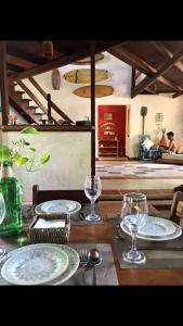 a table with plates and glasses on top of it at Dellacasa in Jericoacoara