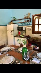 a table with two wine glasses and a bottle on it at Dellacasa in Jericoacoara