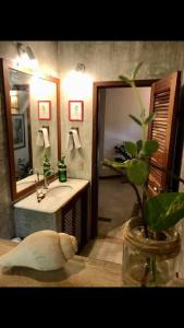 a bathroom with a sink and a mirror at Dellacasa in Jericoacoara +45 photos