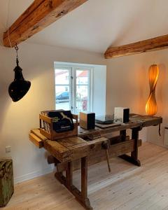 a room with a wooden table and a window at The Mill House - Saeby Watermill in Sæby +89 photos