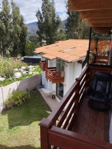 einen Balkon eines kleinen Hauses mit einem Stuhl in der Unterkunft Chullpa's House in Urubamba