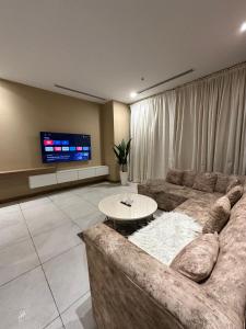 a living room with a couch and a table at full luxury one bed apartment with maid room penta square in Lahore