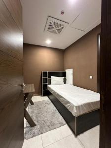 a bedroom with a bed in a room with a ceiling at full luxury one bed apartment with maid room penta square in Lahore