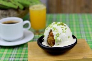 a cup of coffee and a plate of food with a doughnut at Nativa Bambu Ecolodge in Montañita