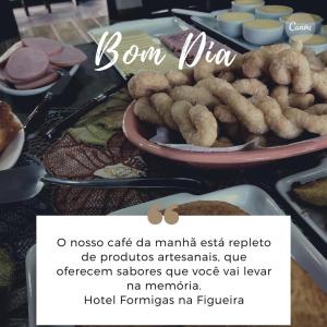 a table with a plate of food on it at Hotel Formigas na Figueira in Tibagi