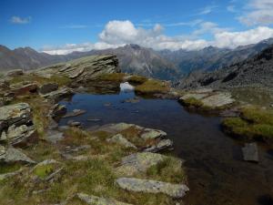 a small lake on the side of a mountain at Albergo du Soleil in Cogne