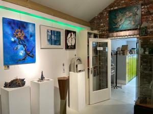 a room with paintings on the walls of a museum at 't ouw ateljeeke in Budel