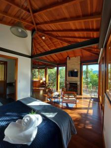 a bedroom with a blue bed and a living room at Alto de Santa Barbara in São Francisco Xavier +41 photos