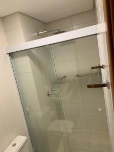 a glass shower in a bathroom with a toilet at BALI BEACH HOME CLUB Piçarras in Piçarras