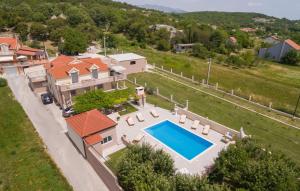 an aerial view of a house with a swimming pool at Apartment Marendić in Obrovac Sinjski