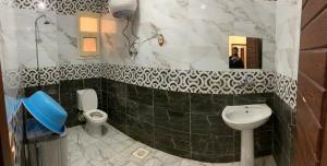 a bathroom with a sink and a toilet and a mirror at Almanara Hotel Marsa Matrouh in Marsa Matruh
