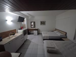 a room with two beds and a sink in it at Apart-Hotel em Tambaú - Super Central com Vista Mar - Ap.113 in João Pessoa