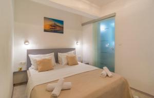 a bedroom with a bed with two towels on it at Apartment Marendić in Obrovac Sinjski +37 photos