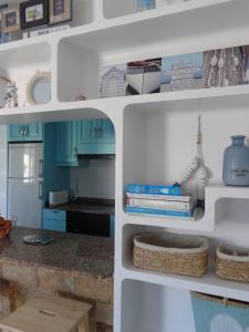a kitchen with a white shelf with books at Apartment Luz De Faro in Playa Honda