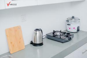 a kitchen counter with a stove and a coffee maker at Virooz Residence Rathmalana 2 Bedroom Apartment in Borupane