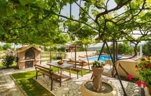 a patio with a table and chairs and a pool at Apartment Marendić in Obrovac Sinjski