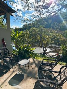 a group of chairs and a table on a patio at Eco Flat 322 - Hotel Fazenda Pedra do Rodeadouro in Bonito