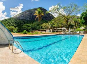 a swimming pool with a mountain in the background at Eco Flat 322 - Hotel Fazenda Pedra do Rodeadouro in Bonito
