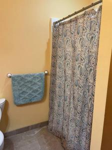 a bathroom with a shower curtain and a towel at Beach Casita - Allyn Inn in Shelton