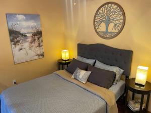 a bedroom with a bed and two lamps on tables at Beach Casita - Allyn Inn in Shelton