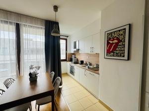 a kitchen with a table and a dining room at Bp-EST CP in Budapest